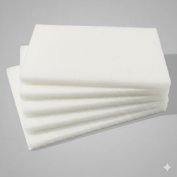 Stack of white scrubbing pads on a gray background
